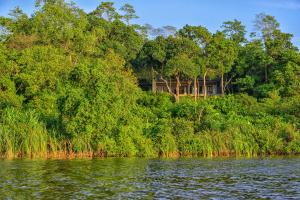 a house on the side of a river with trees at Minnehaha Bentota in Bentota