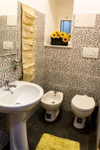 ジェノヴァにあるOTTO rossoのバスルーム(洗面台、トイレ付)、窓が備わります。
