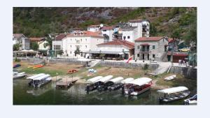 a group of boats are docked in the water at Apartman Sofranac in Rijeka Crnojevića