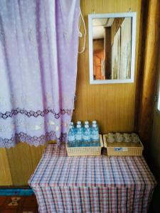 a table with bottles of water and a window at Huen Sabaidee Soi 8 in Chiang Khan