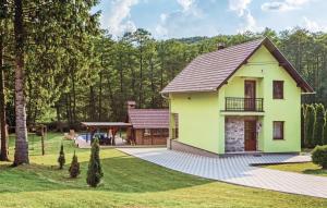 a yellow house with a black roof at Vila Tena in Novo Zvecevo