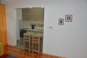 a kitchen with a small island in a room at Sarajevo City Center in Sarajevo