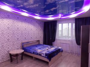 Gor'kogoにあるApartaments LUX STATUS Moskovsky Prospektの紫色の天井のベッドルーム1室(ベッド1台付)