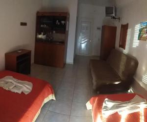 a room with a bed and a couch and a kitchen at Vangelis in Nea Vrasna