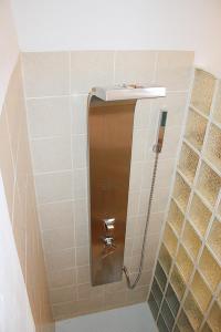 a shower stall in a bathroom with tiles at Apartment Frasquita Boa in Júzcar