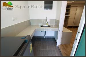 a small kitchen with a sink and a counter at The Prima Residence - SHA Certificate in Bangkok