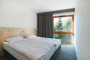 Posteľ alebo postele v izbe v ubytovaní Apartamenty Willowa