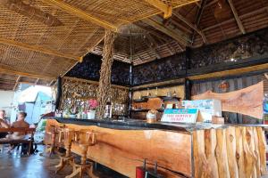 a bar in a restaurant with people sitting at tables at Klongdao Sunset Villa in Ko Lanta