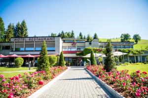 a hotel with flowers in front of a building at Holiday Apartment in Schwarzenberg