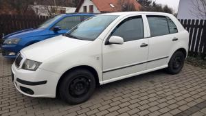 a white car parked next to a blue car at penzion LILIE in Litomyšl