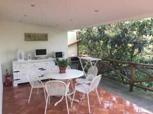 a white table and chairs in a room with a table and a window at Chalet Paradiso in Sorrento