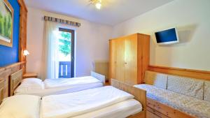 Postel nebo postele na pokoji v ubytování Hotel Garni Edy
