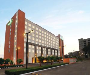 un gran edificio de ladrillo con luces en una calle en Lemon Tree Hotel, Sector 68, Sohna Road, Gurugram en Gurgaon