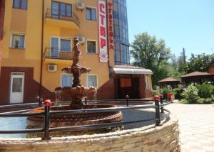 a water fountain in front of a building at Hotel Star in Stryi