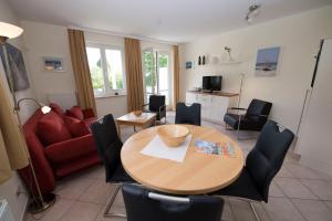 a living room with a wooden table and chairs at Wohnpark Stadt Hamburg - Apt. 37 in Binz