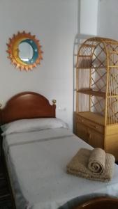 a bedroom with a bed with a mirror on the wall at Apartamento el Benicadell in Adzaneta de Albaida