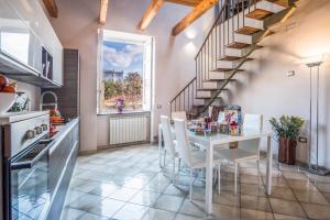 a kitchen and dining room with a table and stairs at Amore Rentals - Appartamento Caruso in Sorrento