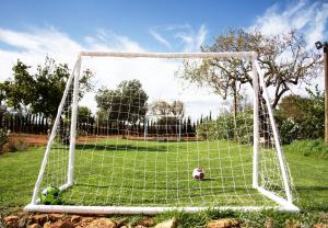 a soccer ball is sitting in front of a net at Agroturismo Can Pere Rei in Son Serra de Marina