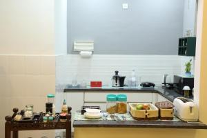 a kitchen with a counter with some food on it at Bed n Oats in Gurgaon
