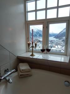 a bathroom with a sink, toilet and window at Vikinghaug in Odda