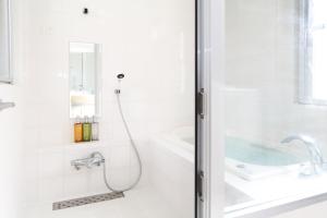 a white bathroom with a shower and a sink at Palm Villa Ishigakijima igusa in Ishigaki Island +25 photos