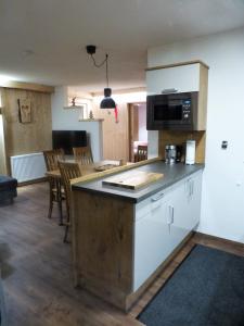 a kitchen with a counter top and a kitchen with a table at Chalet Auszeit in Arzl im Pitztal