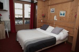 מיטה או מיטות בחדר ב-Hôtel Val d'Este