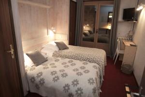 Postel nebo postele na pokoji v ubytování Hôtel Val d'Este