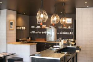 a kitchen with two lights and a counter top at Hôtel Val d'Este in Saint-Gervais-les-Bains