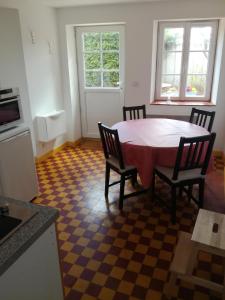 a kitchen with a table and chairs in a room at Ma Petite Maison Chambourgeoise in Chambourg-sur-Indre