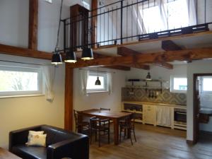 a dining room and kitchen with a table and chairs at Apartmány Stodola n.30 in Stříbřec