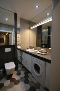 a bathroom with a washing machine and a sink at Apartament "Park Lotników" in Kraków +21 photos