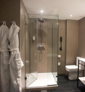 a glass shower in a bathroom with a toilet at Mercure Madrid Centro in Madrid