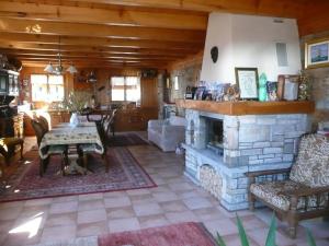 a living room with a stone fireplace and a table at Chalet Vaclav in Sixt