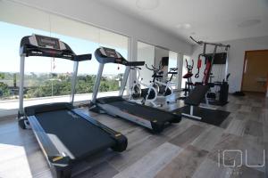 a gym with several treadmills and machines in a room at IQU Apart in Las Gaviotas