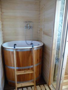 a wooden bath tub with a ladder in a bathroom at Apartamenty Widokowa Korbielów in Korbielów +62 photos