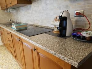 a kitchen counter with a coffee maker on it at B&B Buscemi in Pistoia