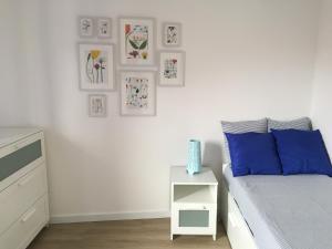 a white bedroom with a bed and a white nightstand at Casa da Fonte in Foz do Arelho