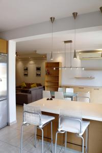 a kitchen and living room with a table and chairs at Kornesios Suite in Nicosia