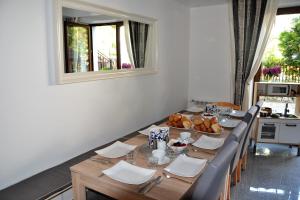 een eetkamer met een tafel met brood en een spiegel bij Apartamenty Villa 28 in Pobierowo