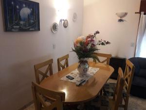 un tavolo da pranzo con un vaso di fiori sopra di Casa Galicia a San Bernardo Altre 7 foto