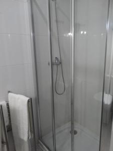 a shower stall with a glass shower door at Hotel Porto Rico in Porto