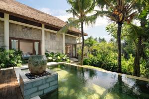 a large stone building with a pool of water in front of it at The Purist Villas & Spa Ubud in Ubud