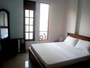 Postel nebo postele na pokoji v ubytování Kandy Citylights Residence