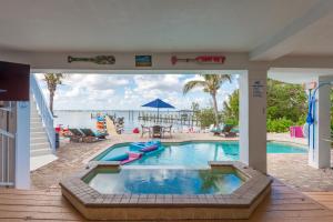 a swimming pool with a view of the water at Aquarius North in Stuart