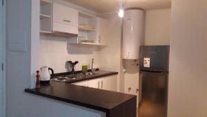 a kitchen with a refrigerator and a counter top at Lomas de Papudo III in Papudo