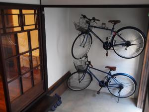 Dos bicicletas están colgadas en una pared en Kaika Minamino Ie, en Kioto