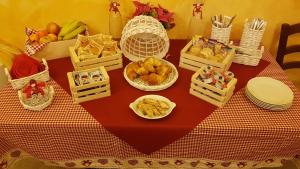 a table with baskets of food and fruit on it at La Locanda dei Cavalieri Affittacamere in Lugagnano Val dʼArda