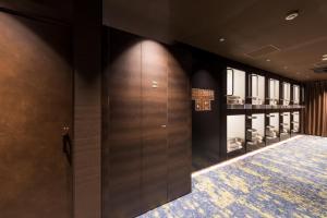 a walk in closet with wooden doors and a rug at Glansit Akihabara in Tokyo