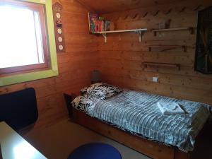 a bedroom with a bed in a log cabin at Arpege Des Neiges in Sainte-Foy-Tarentaise